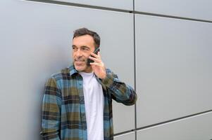 Smiling man talking on smartphone photo