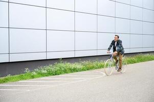 Smiling man with bicycle on road photo