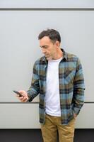 Smiling man using smartphone photo