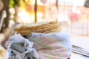 Stack of Mexican flatbreads on wrapped fabric photo