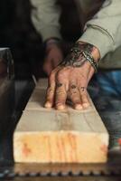 Crop carpenter working with wood in workshop photo