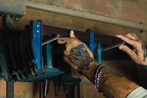 Anonymous man using carpentry tool in workshop photo