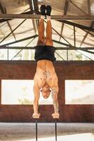 athletic man doing a vertical handstand. calisthenics photo