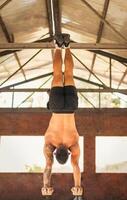 athletic man doing a vertical handstand photo