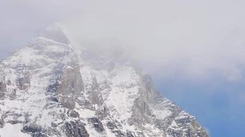 Aerial view of Cervino Ski Paradise and Cervino town with the Matterhorn mountain. Snow covered peaks and mist are revealed in a sweeping motion. video