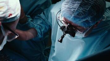 Surgery, icu or surgeons with teamwork for emergency, accident or healthcare in hospital clinic. Light, medical operation or doctors in surgical collaboration in operating room to support or help video