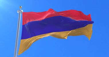 Armenia flag at wind in slow with blue sky, loop video