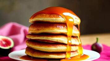 Pouring Syrup on Stack of Pancakes with Fig on Plate video