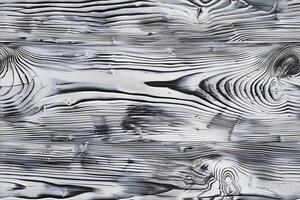 Textured wooden surface with a black and white finish, showcasing intricate grain patterns and lines. photo