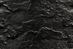 A close up of a black rock surface photo