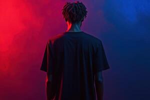 A man with dreadlocks standing in front of a red and blue smoke photo