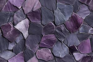 A textured wall made of variously shaped purple and gray slate stones, creating a natural and artistic pattern. photo