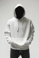 Man in white hoodie standing in front of white background photo