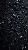 A textured black background featuring intricate floral patterns and swirls, creating a sophisticated and elegant design. photo