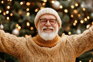 An old man with a beard and sweater is standing in front of a christmas tree photo