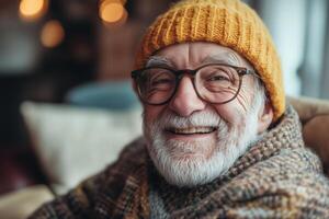 An older man with glasses and a yellow hat smiling photo