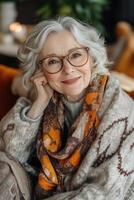 An older woman wearing glasses and a scarf sitting on a couch photo