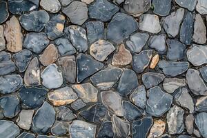 A close up of a stone wall with many different types of rocks photo