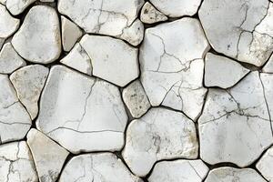 A white stone wall with cracks and cracks photo