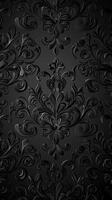 A textured black wallpaper featuring intricate floral patterns and swirls, creating a sophisticated and elegant design. photo