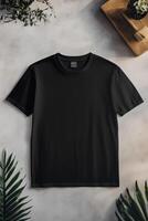 A black t - shirt with a green plant on top photo