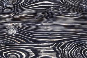 A black and white photo of wood with wavy lines