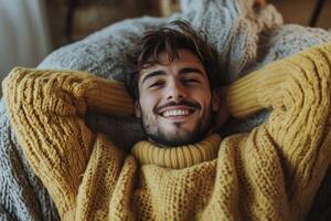 A man in a yellow sweater is smiling photo