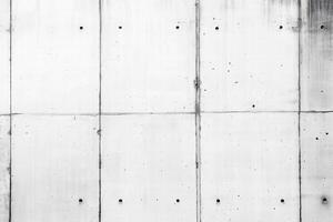 Seamless textured concrete wall with visible seams and small holes, showcasing a minimalist and industrial aesthetic. photo