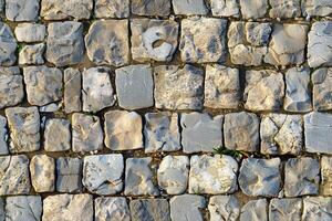 A stone wall with many different types of stones photo