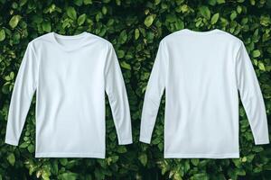 Two white long - sleeved t - shirts mock up on a green background photo