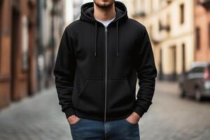 Man in black hoodie standing on street photo