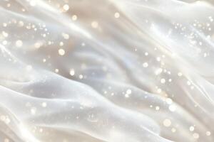 A soft, flowing white fabric with a dreamy, ethereal quality, featuring subtle sparkles and a smooth texture. The background is blurred, creating a serene and elegant atmosphere. photo