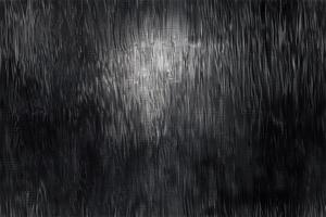 A black and white photo of a light shining through a window