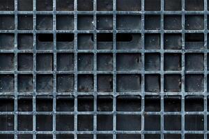 A close up of a metal grate with holes photo