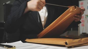 A person in a suit holding a folder video