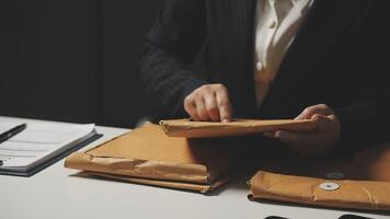 A person in a suit is holding a brown envelope video