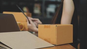 A woman is using a laptop and a box on a table video