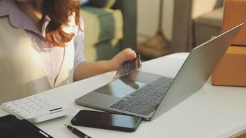 A woman is using a laptop and a credit card video