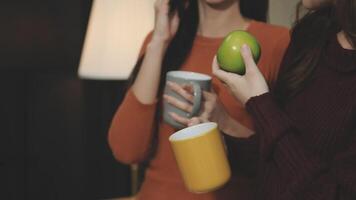 Two women holding coffee cups and talking on the phone video