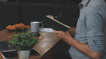 Man reading a book at desk video
