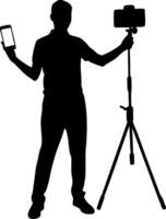 Silhouette of a Person Holding a Smartphone and a Tripod for or Videography vector