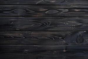 Dark, charred wooden planks with a smooth texture and visible grain patterns, creating a rustic and modern aesthetic. photo