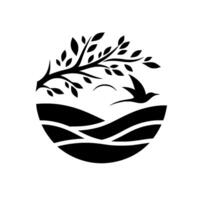 A circular black and white minimalist depicting a bird in flight soaring over stylized rolling hills and beneath a tree. vector