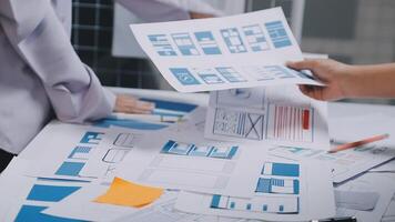 A man and woman are working on a project with papers and blueprints video