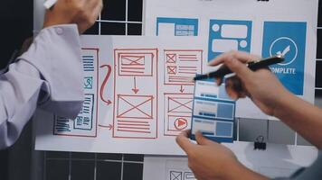 Two people are working on a whiteboard with a design on it video