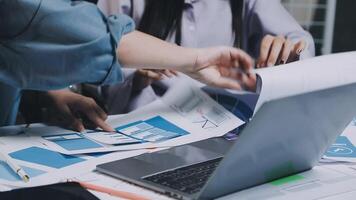 Two people working on a laptop with papers and papers video