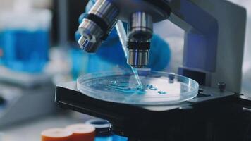 A microscope is being used to look at a liquid video