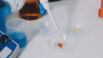 A person is holding a pipette and some liquid video