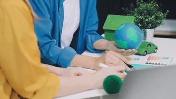 Two people are working on a laptop and a globe video