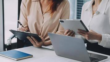 Two women are working on their laptops and tablets video